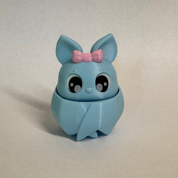 Blue bat fidget clicker with a pink bow