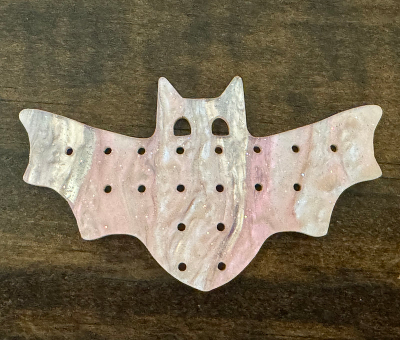 Bat shaped earring pallet in pink marble acrylic with holes for 18 pairs of earrings