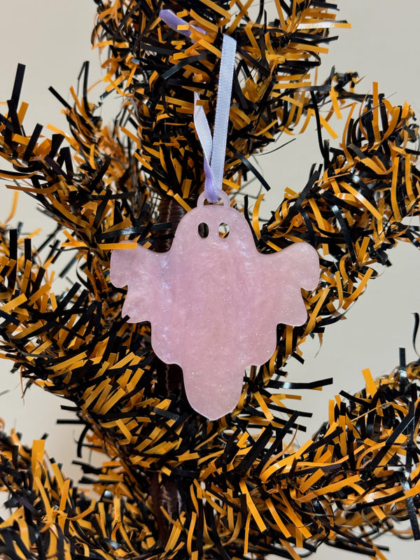 Pink marbled acrylic ghost ornament on an orange and black Halloween tree